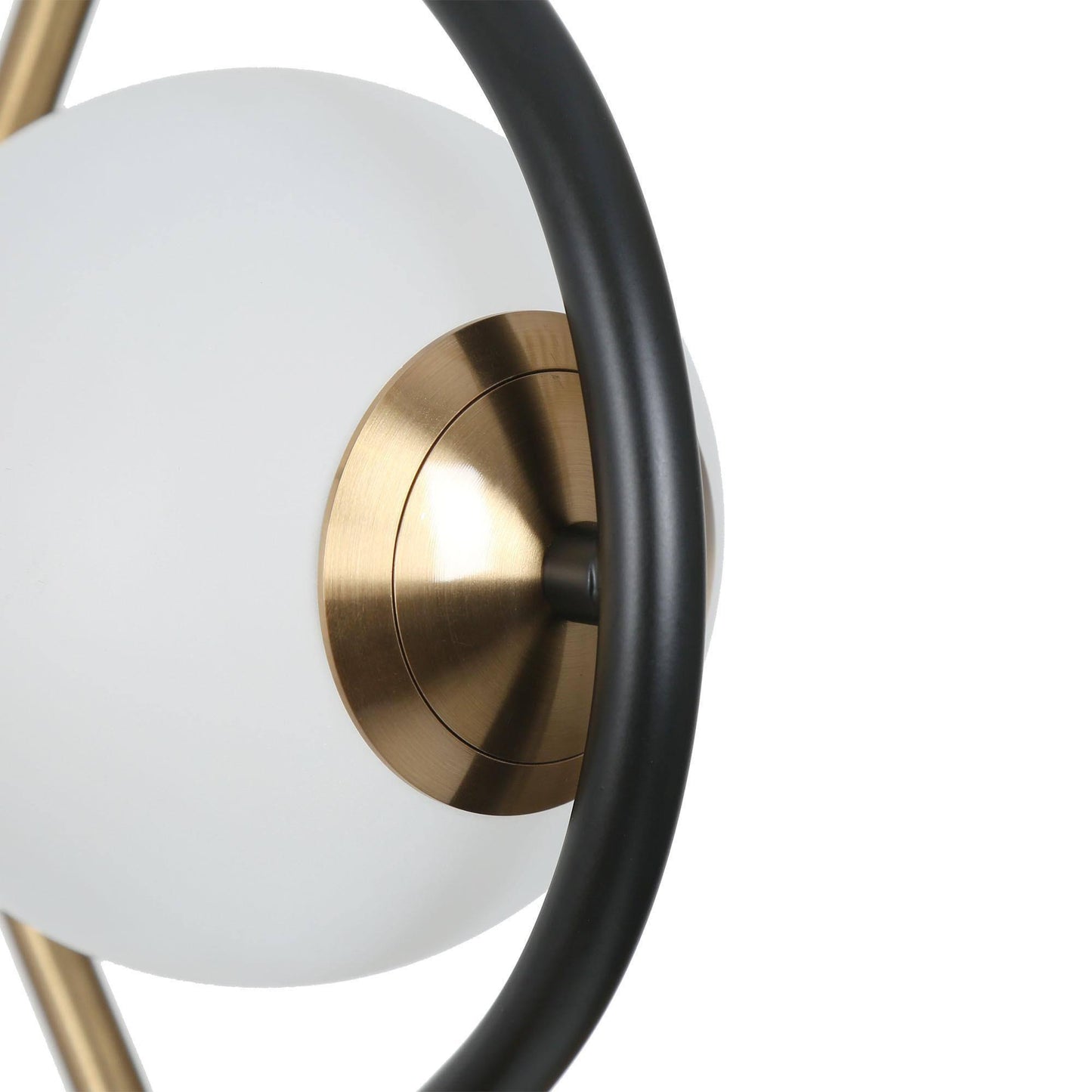 Close-up view of a modern pendant light's white glass globe with a surrounding gold frame detail.